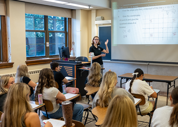 Amanda Manning teaches a small group of students in a classroom.